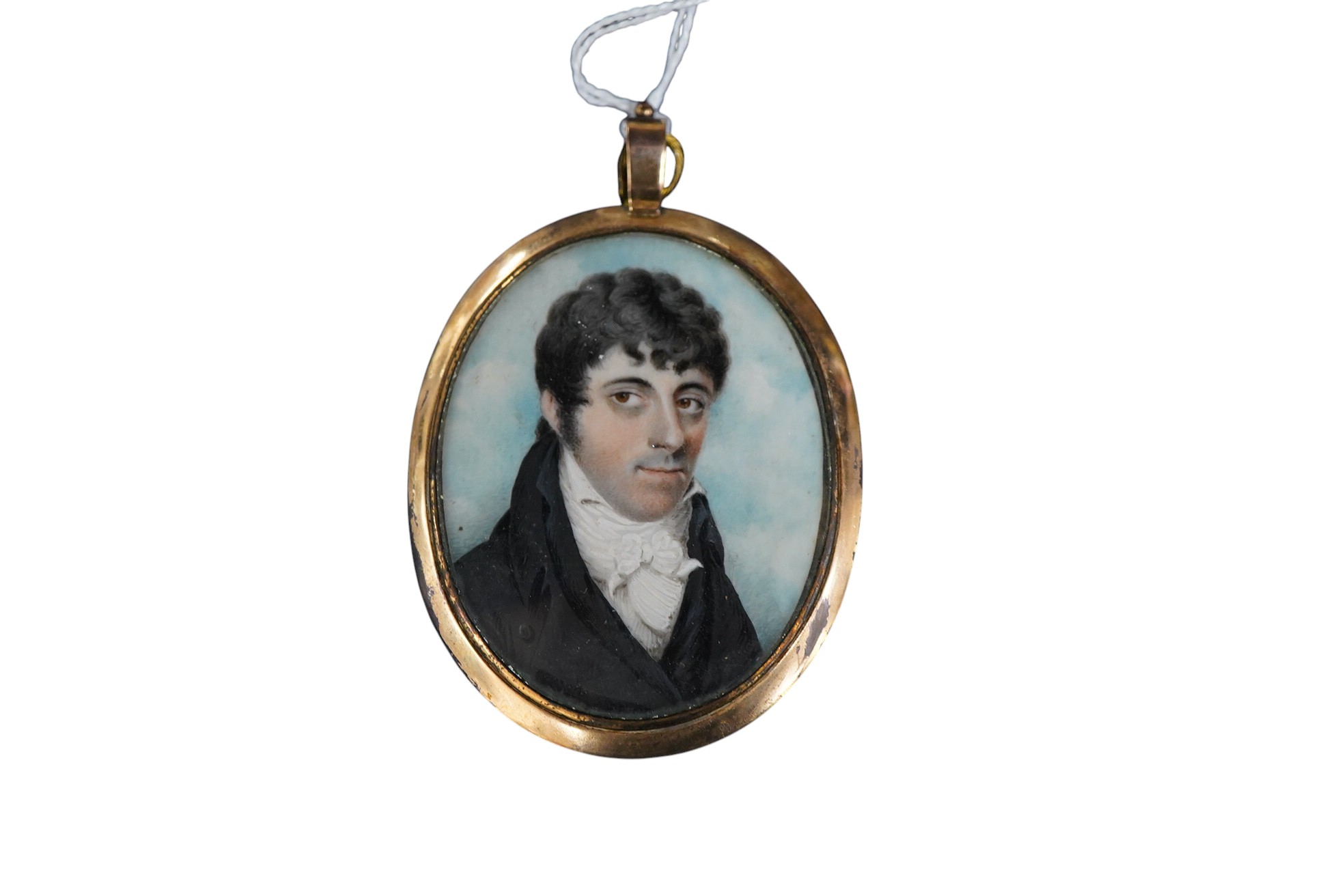 Regency School, Portrait miniature of a young gentleman wearing a frock coat, oval watercolour on ivory, 6 x 4.5cm, housed in a gilt metal pendant frame CITES Submission reference K7AFBZFN